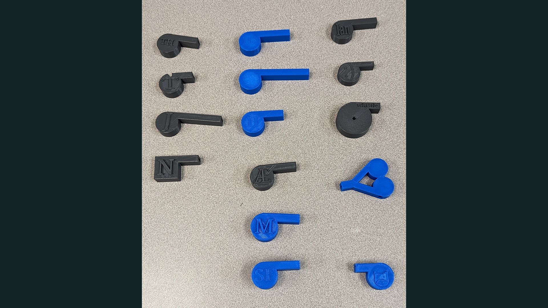 15 3D printed whistles, all varying in design.