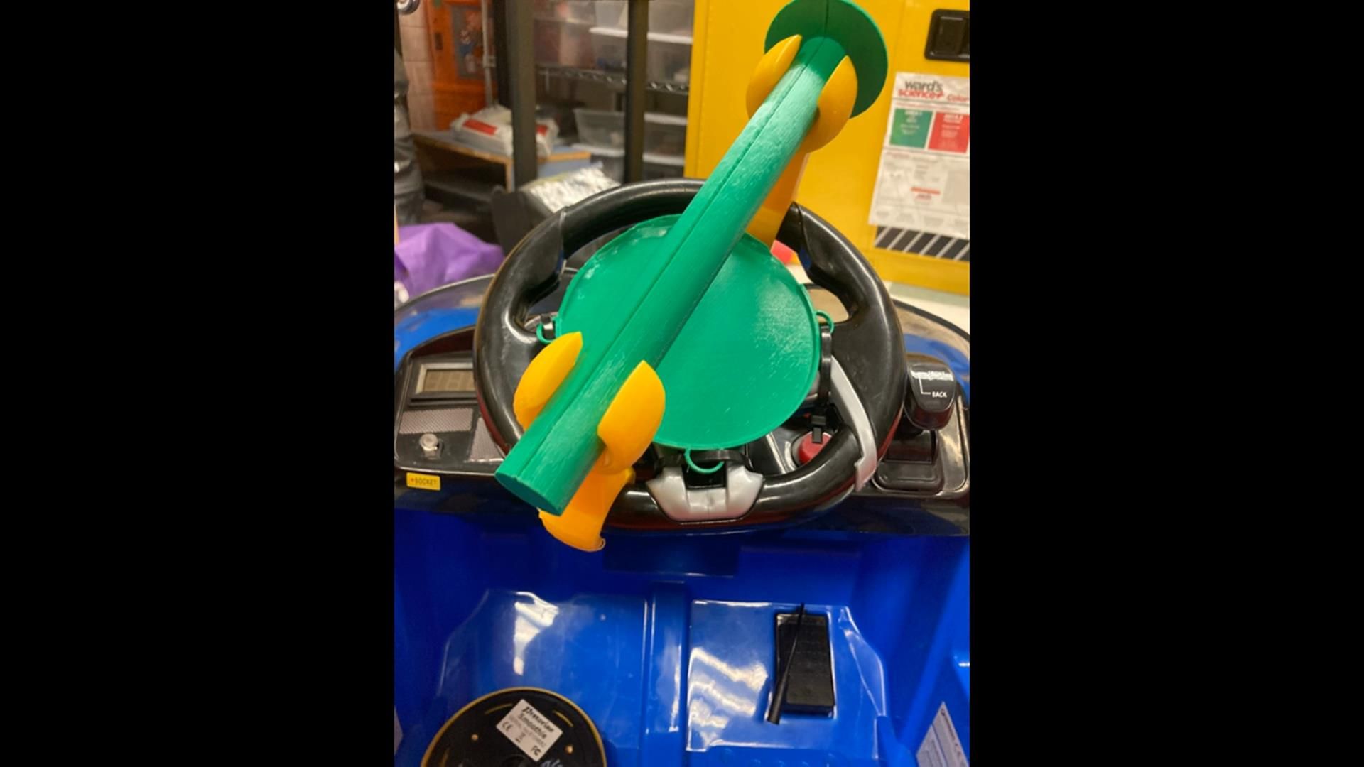 3D printed steering wheel attachment for a toy car.