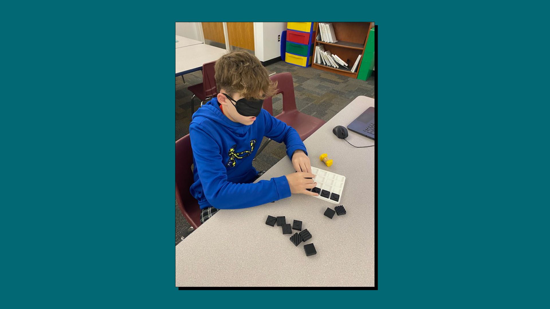 A student playing a 3D printed tactile matching game with textured pieces.