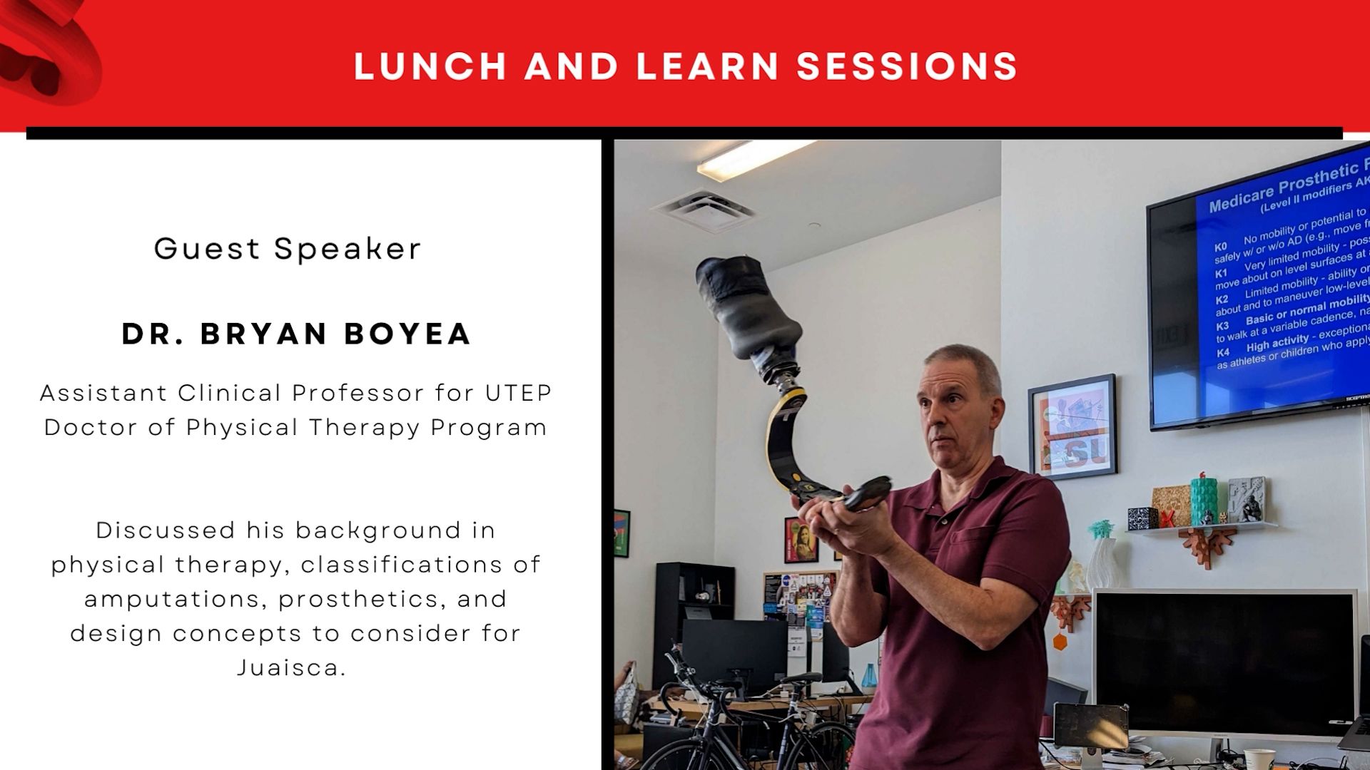 Dr Bryan Boyea holding up a prosthetic device to an audience.