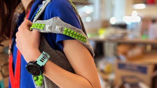A tote bag decorated with a green 3D printed pattern.