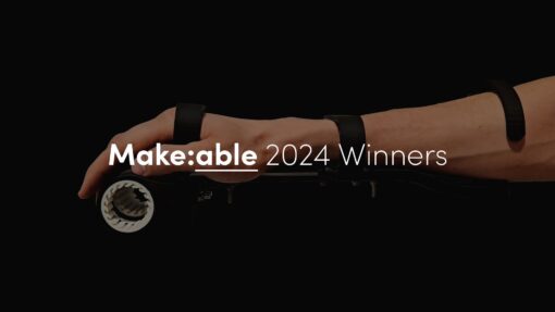 A 3d printed assistive gripping aid with the text 'Make:able 2024 Winners' overlaid.
