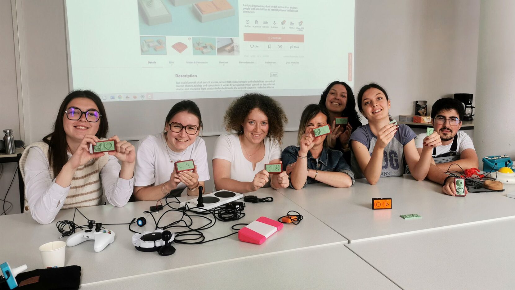 A group of students holding up their 3D printed, assistive 'Tap' switches.