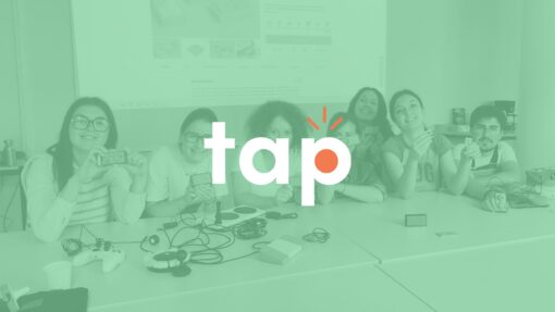 A group of students holding up their 3D printed 'Tap' switches. The Tap logo overlaid in white.