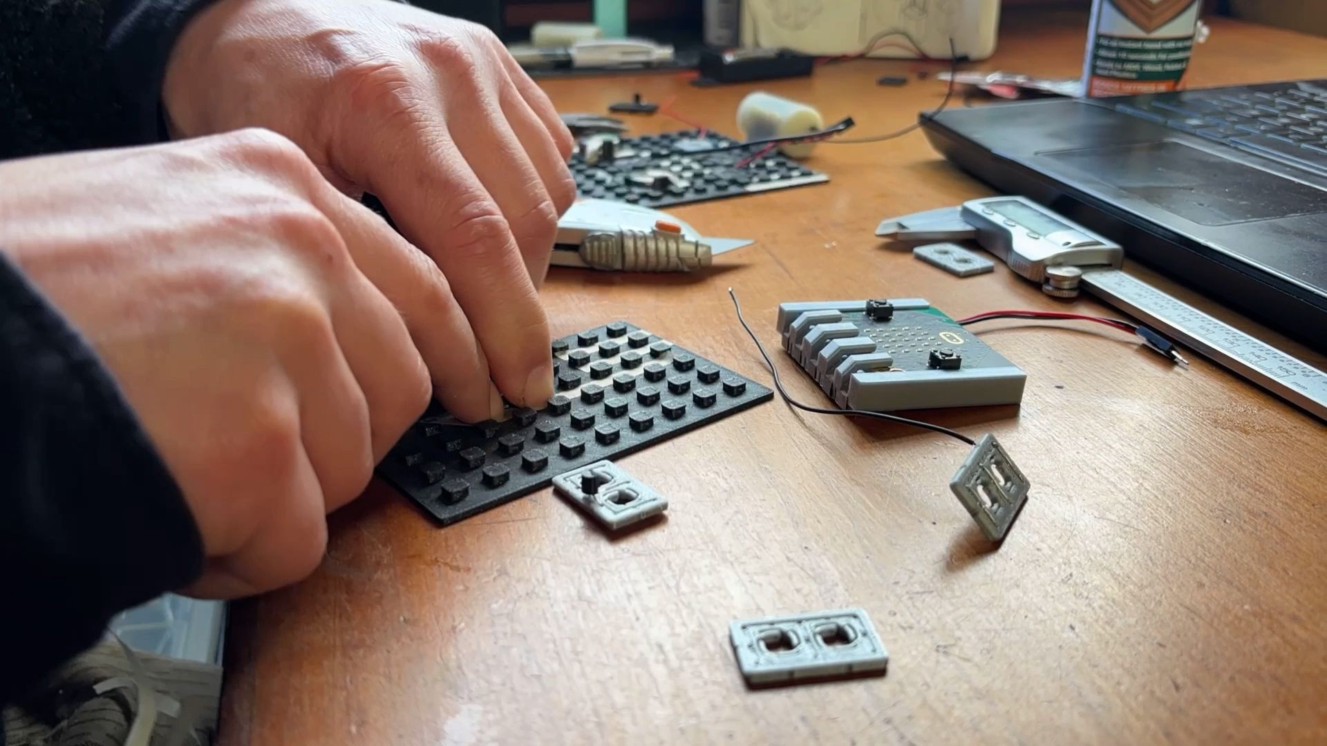PrintLab's lead designer prototyping circuits on a MakerTrack grid board.