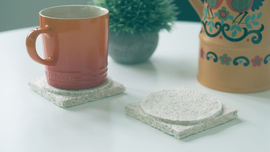 2 coasters made from mycelium - the root-like structures of mushrooms. Both designs are identical and feature a square base with a cylindrical shape on top.