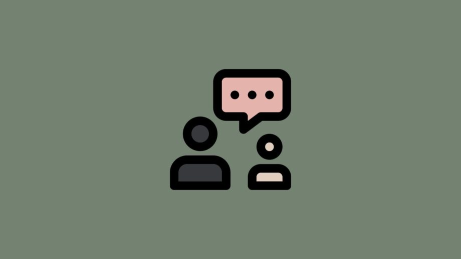 A minimal icon depicting two people side by side with a speech bubble above them. The characters are shown in dark and light neutral tones on a muted green background, representing user research, feedback or understanding an audience.