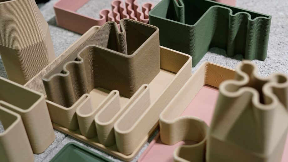 Modular 3D printed homeware organisers with curved compartments, shown in neutral and muted colours.