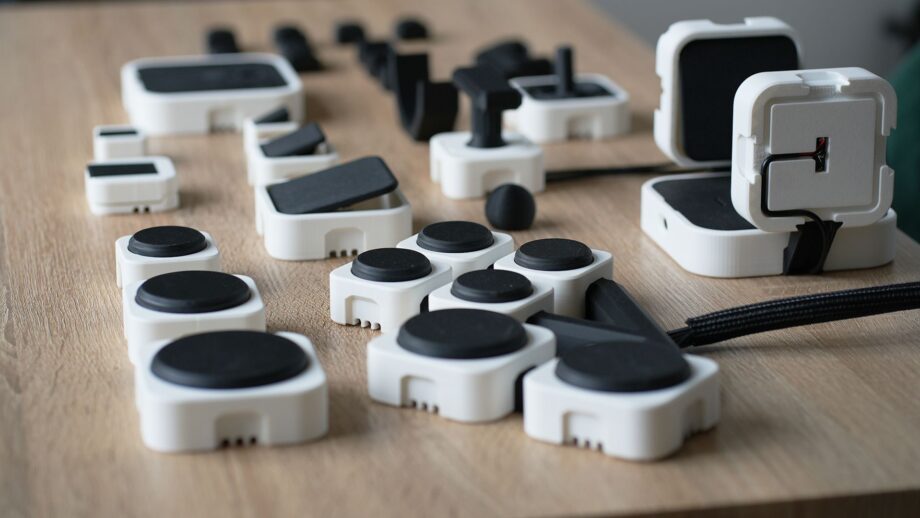 PrintSwitch modular assistive switch ecosystem showing push switches, angled switches, joysticks, connectors and interface modules.