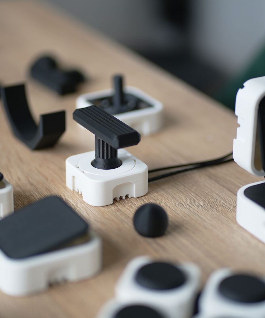 Modular PrintSwitch joystick with interchangeable handle and accessories for accessible input.